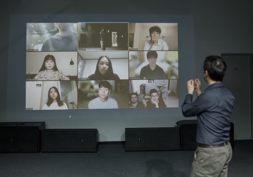 Fotografia wideokonferencji z koreańskimi artystami, którzy wzięli udział w wydarzeniu "Widzialne głosy. Młoda fotografia koreańska dzisiaj!". Zdjęcie wykonane w parakinie, wewnątrz CSW Łaźnia. 